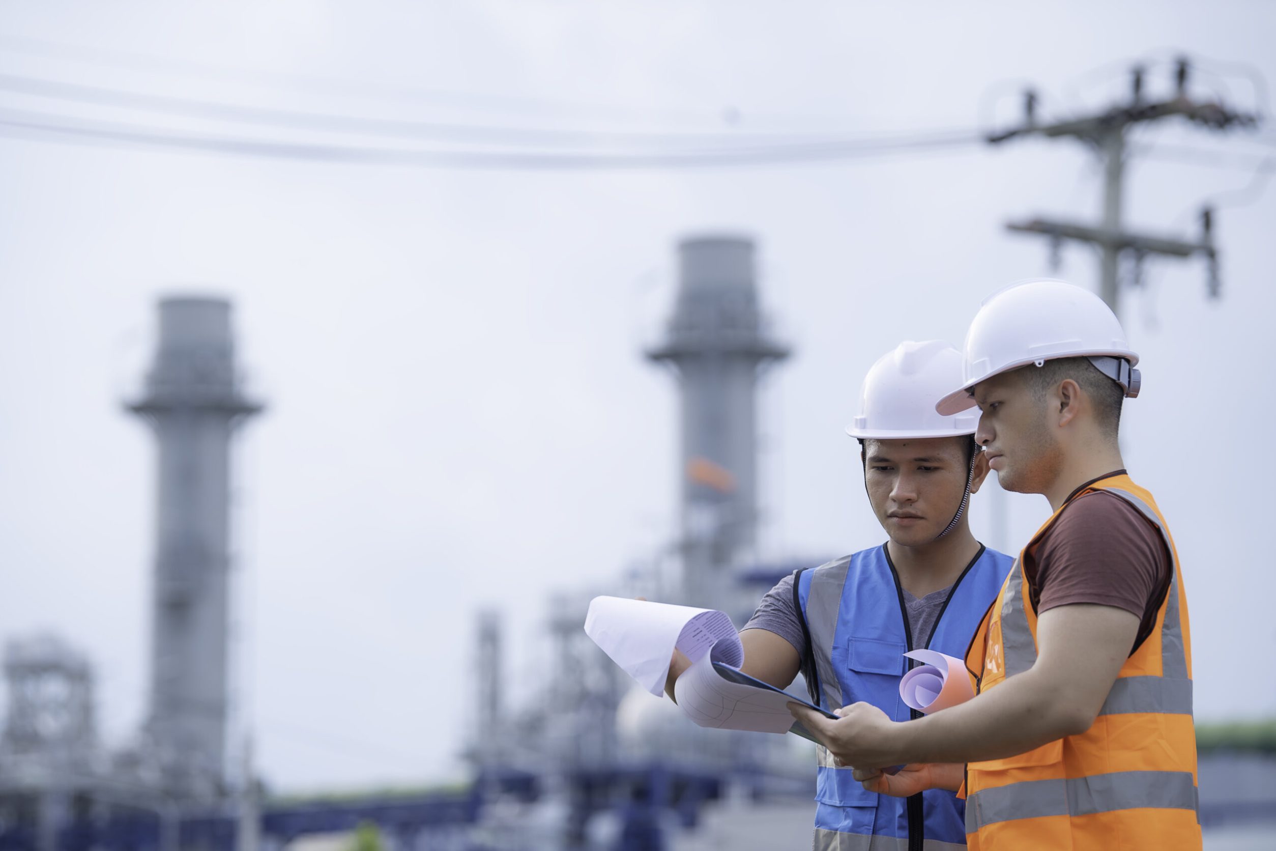Two engineer working at power plant,Work together happily,Help each other analyze the problem,Consult about development guidelines